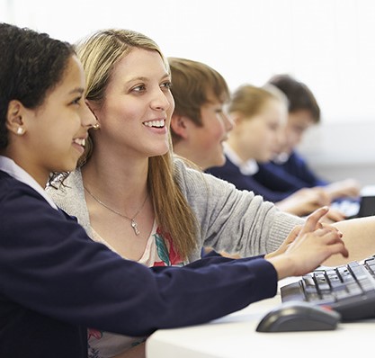 Teacher with Student at Computer